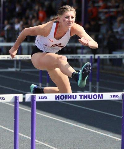 Photo of Olyvia jumping over a hurdle
